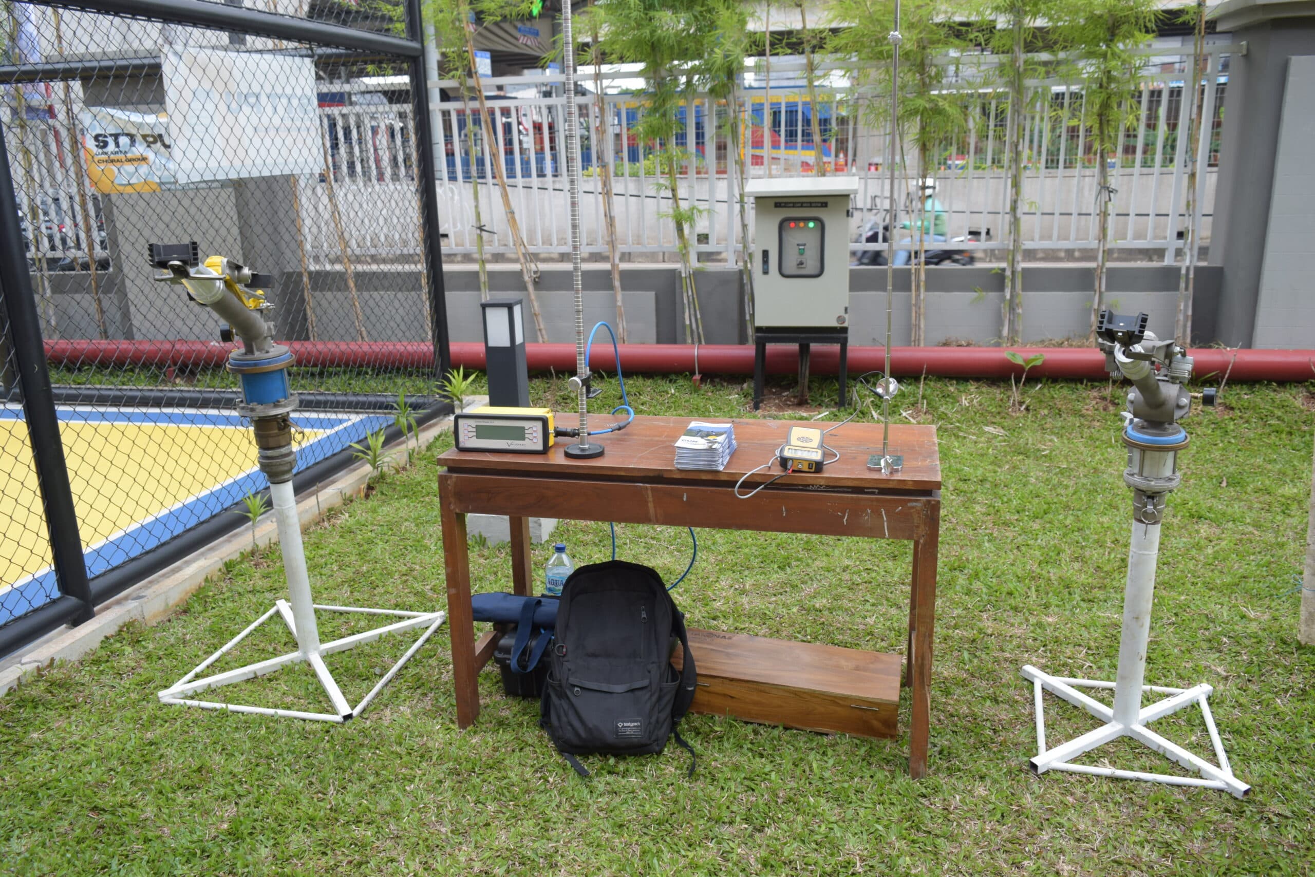 Instalasi pengujian sistem hidrolika dan proteksi kebakaran lapangan. Menampilkan dua unit fire monitor (meriam air) pada dudukan tripod.